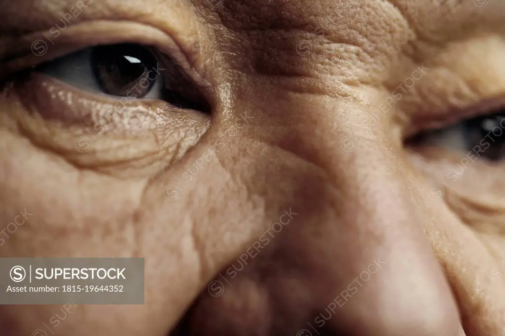 Senior man with wrinkled skin looking away