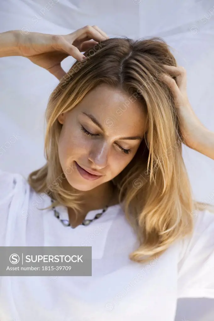 Young woman massaging her head