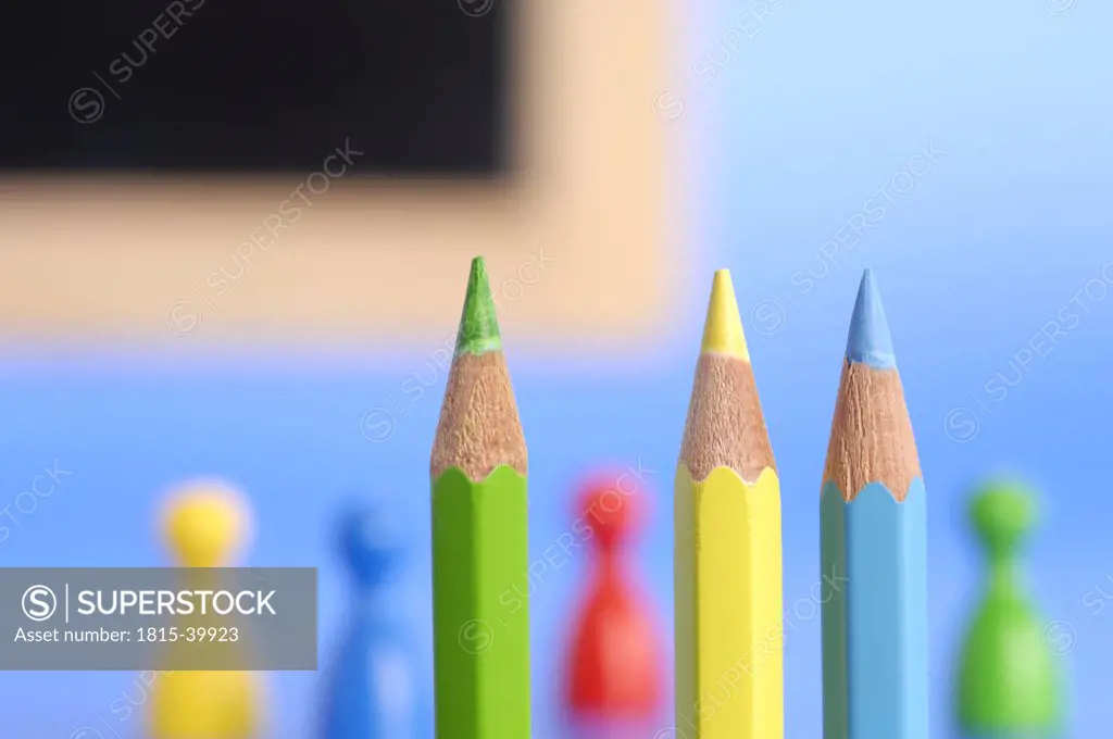 Pencils and game pieces, close-up