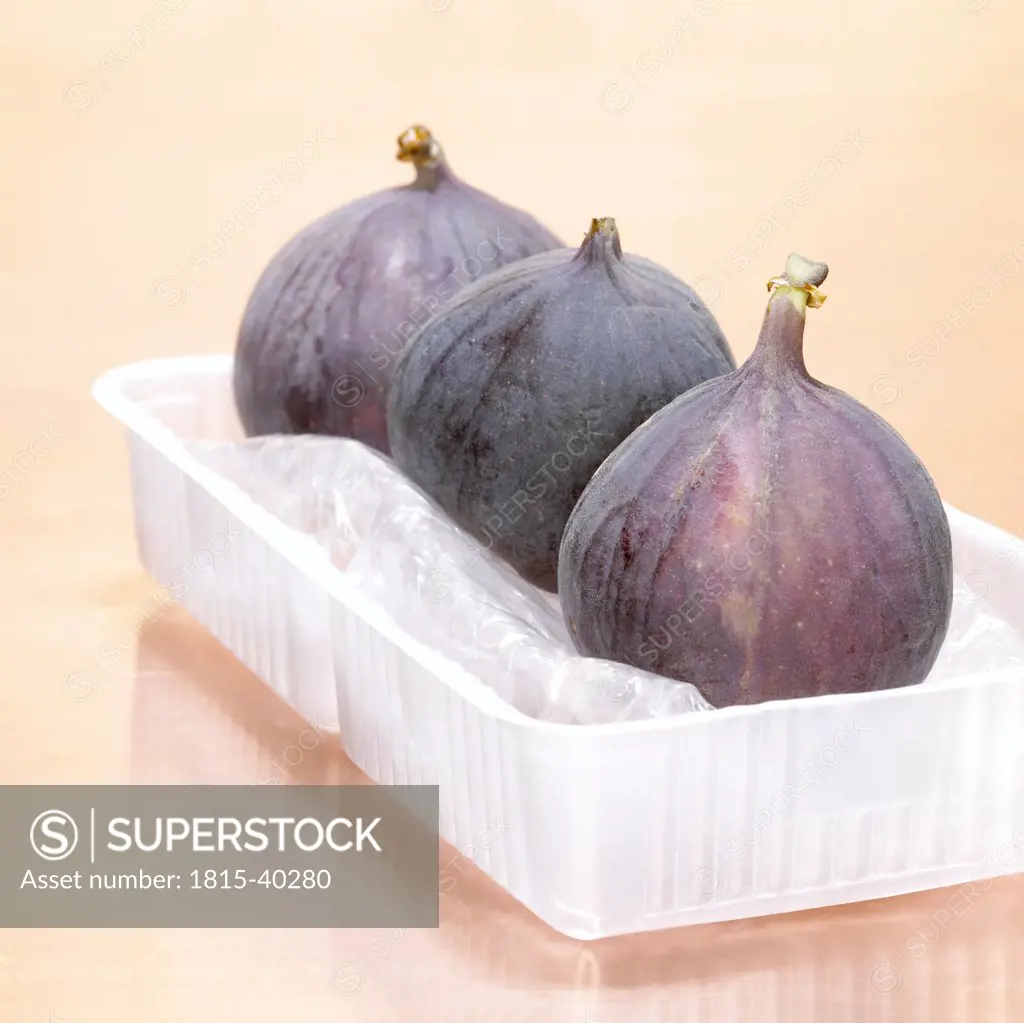 Figs in plastic bowl, close-up