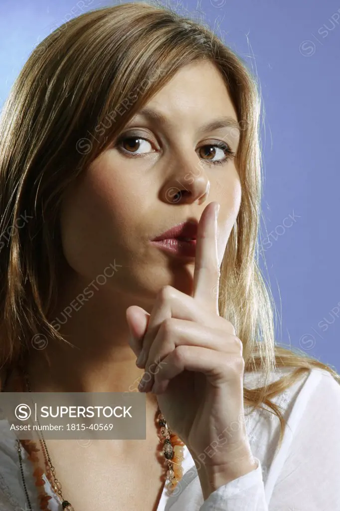 Woman with finger on her lips