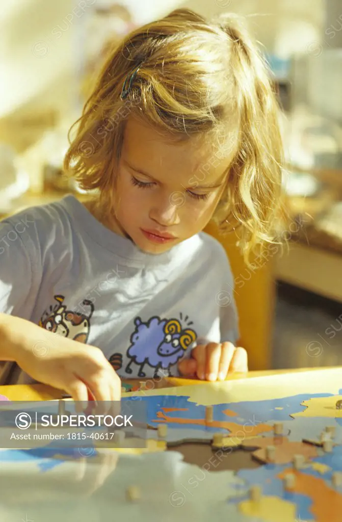 Girl playing with a puzzle