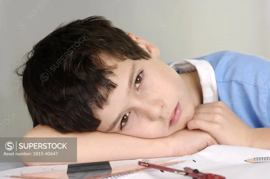 Boy tired from doing his homework