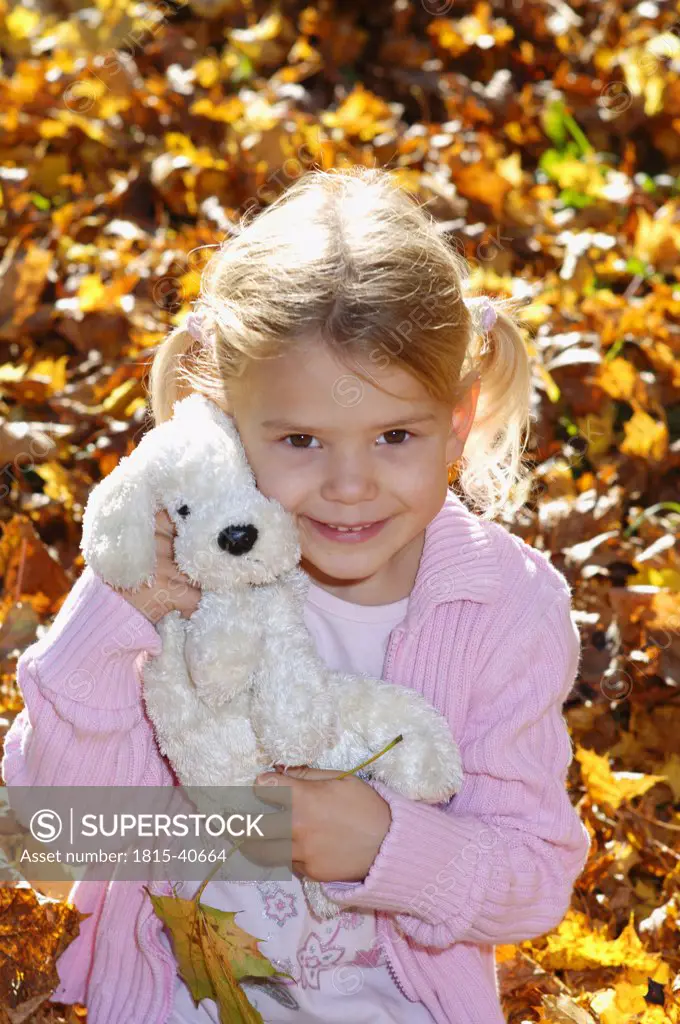 Little girl holding soft toy