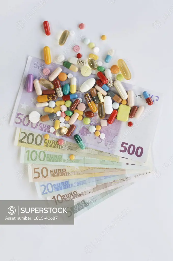 Pills and tablets on top of banknotes