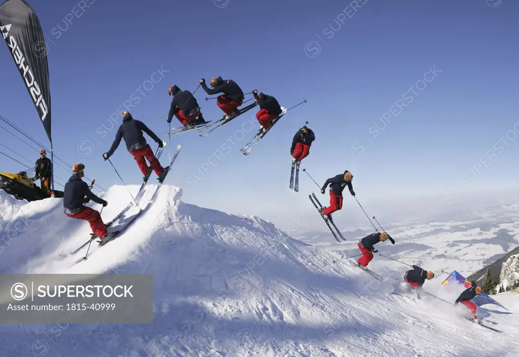 Germany, Bavaria, group of skiers performing jump