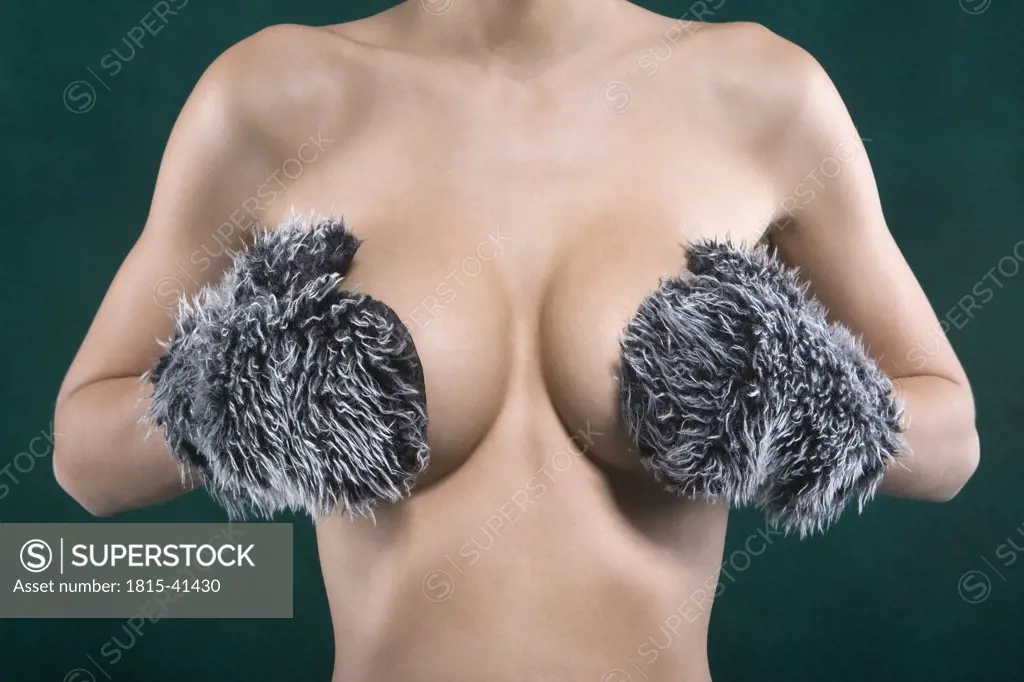 Woman covering her breast, mid section