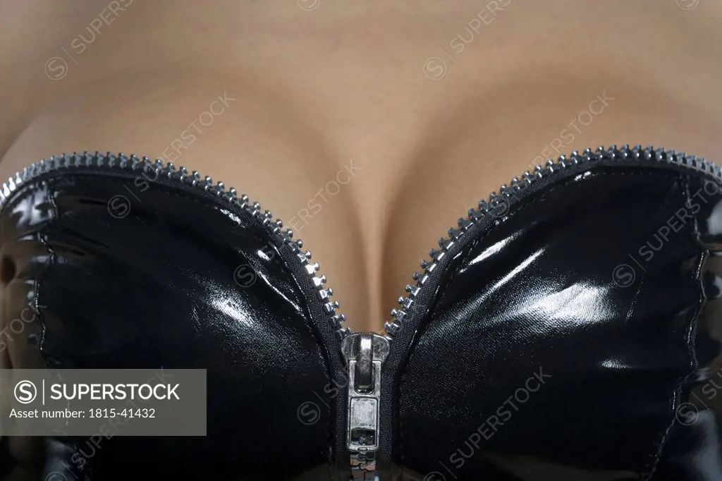 Woman wearing PVC corset, mid section