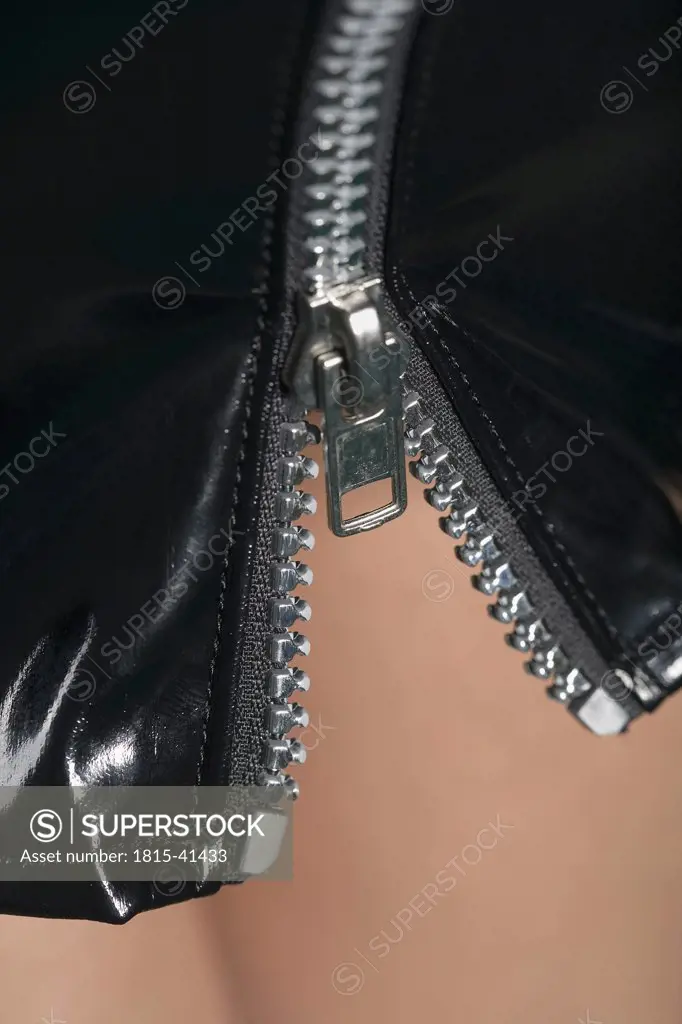 Woman wearing PVC miniskirt, close-up
