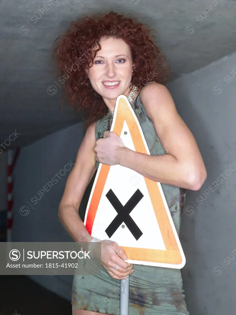 Woman holding traffic sign