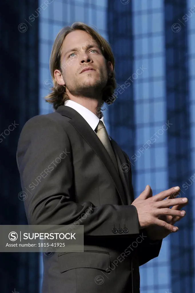Germany, Frankfurt M., young business man in front of Deutsche-Bank-Tower