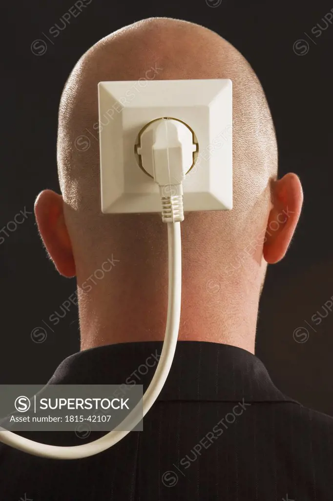 Man with plug and socket on back of head