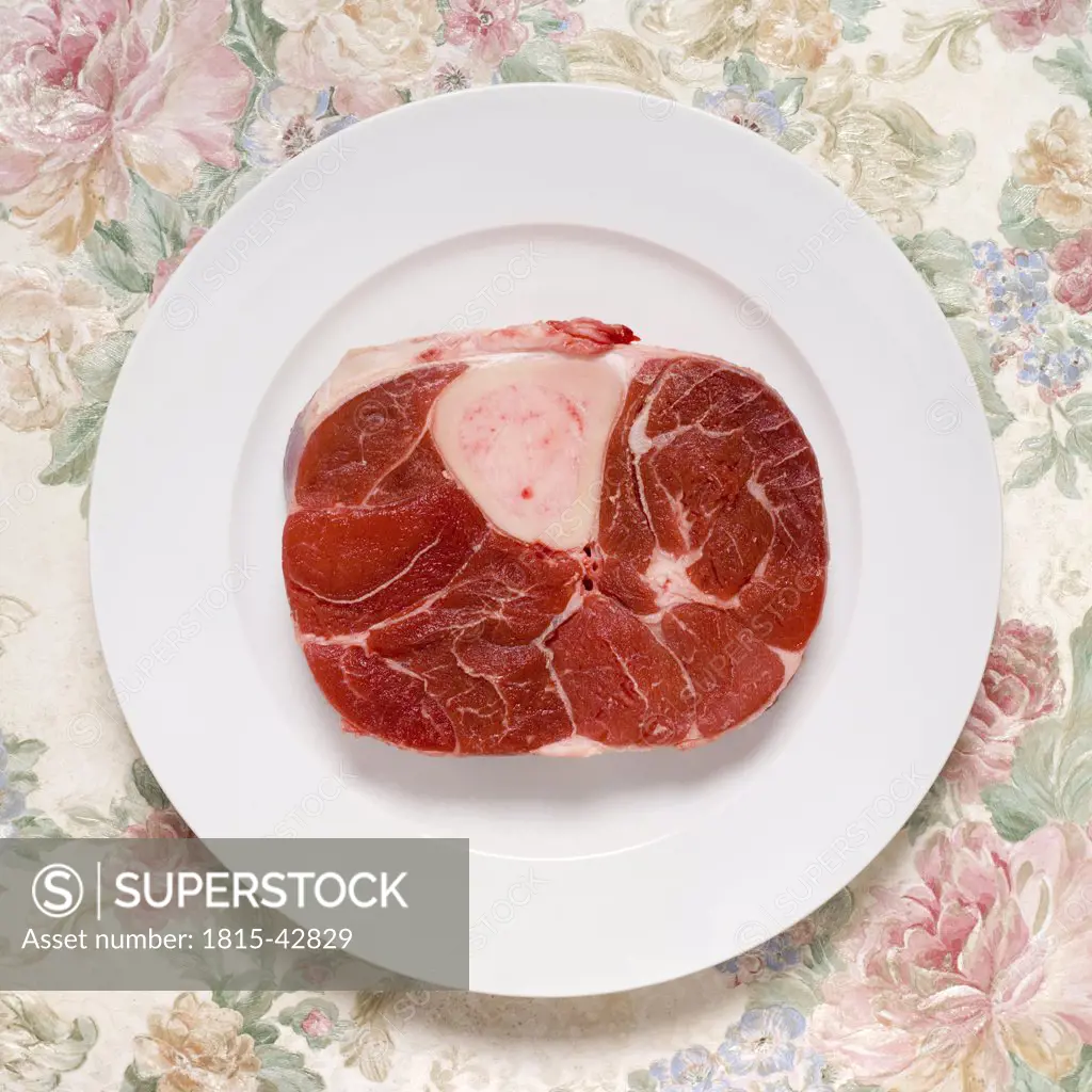 Raw beef shank on plate, elevated view