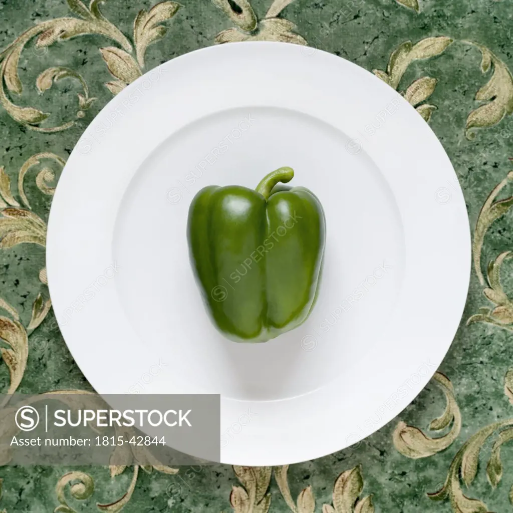 Green pepper on plate, elevated view