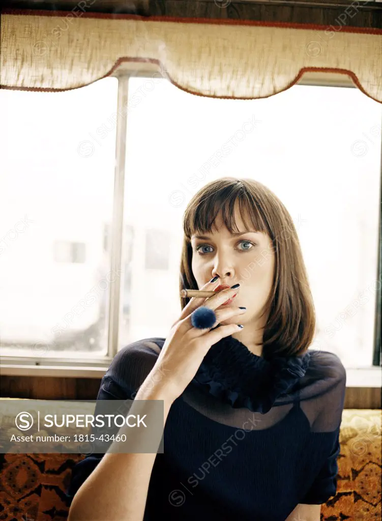 Woman smoking cigar, portrait