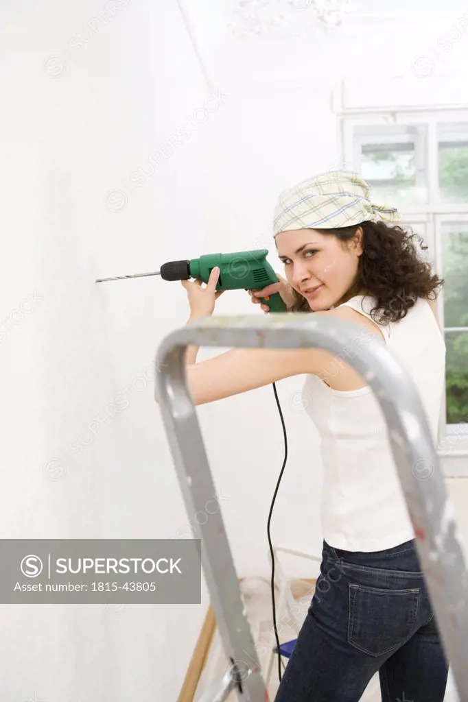 Woman using elecrtric drill