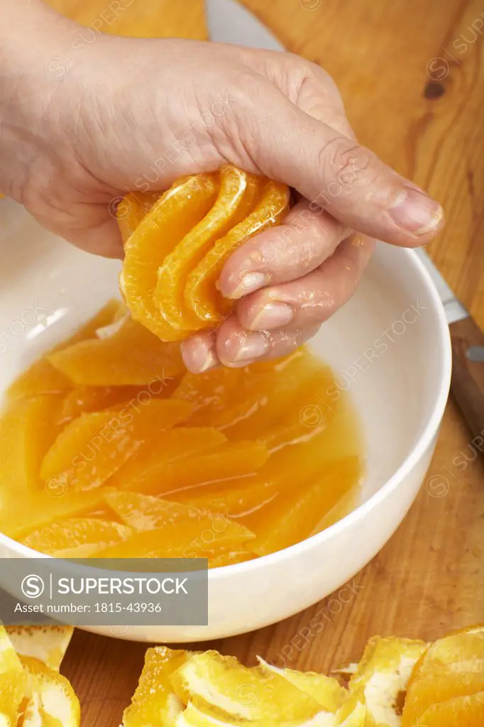 Hand squeezing an orange, close-up