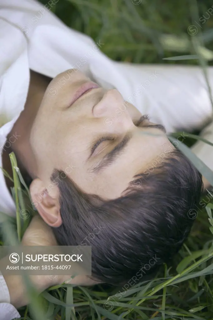 Man sleeping in meadow, close-up