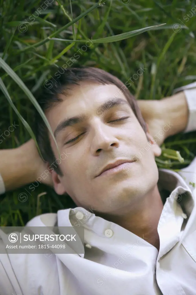 Man sleeping in meadow, close-up