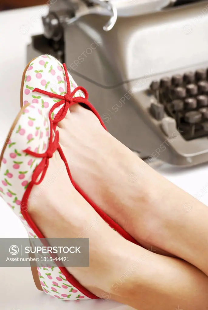 Woman`s feet on desk, close-up