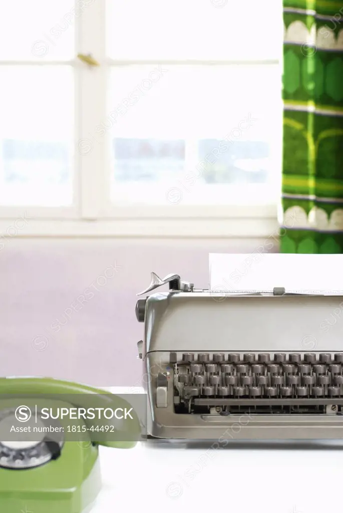 Office desk with phone and typewriter, close-up