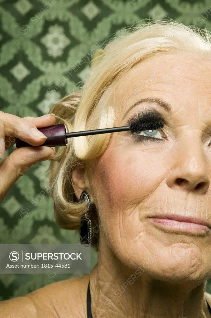 Elder lady applying mascara