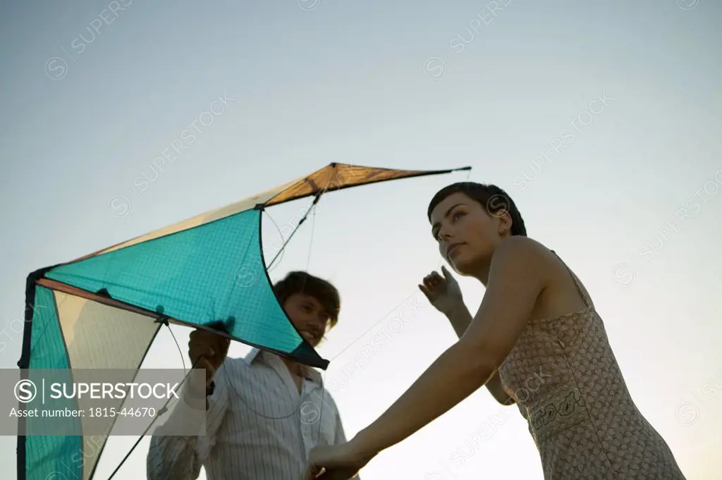 Young couple flying kite
