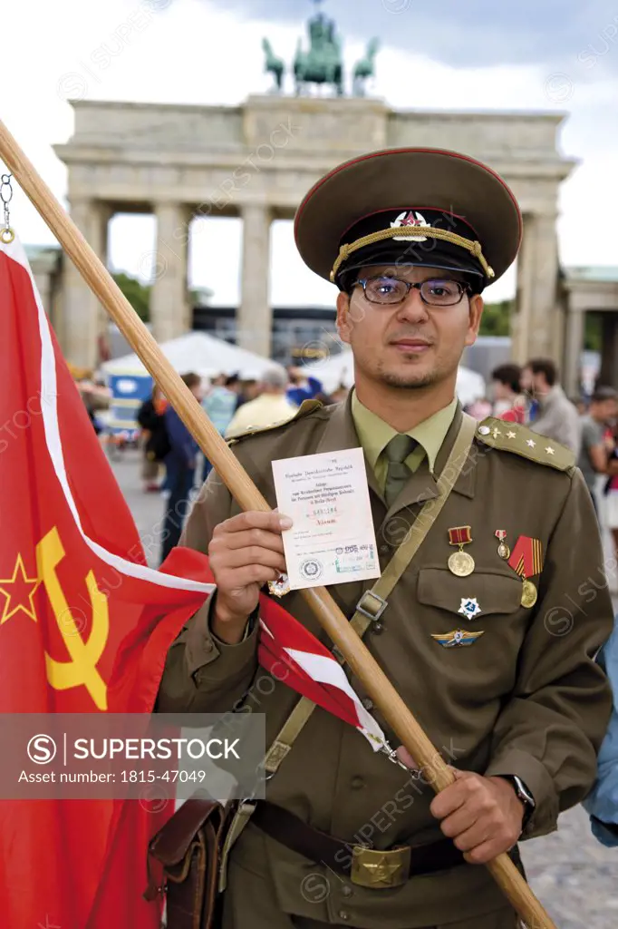 Germany, Berlin, Russian soldier holding transit visa, portrait