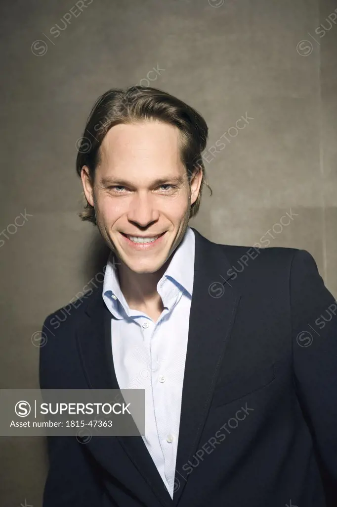 Young businessman, smiling, portrait