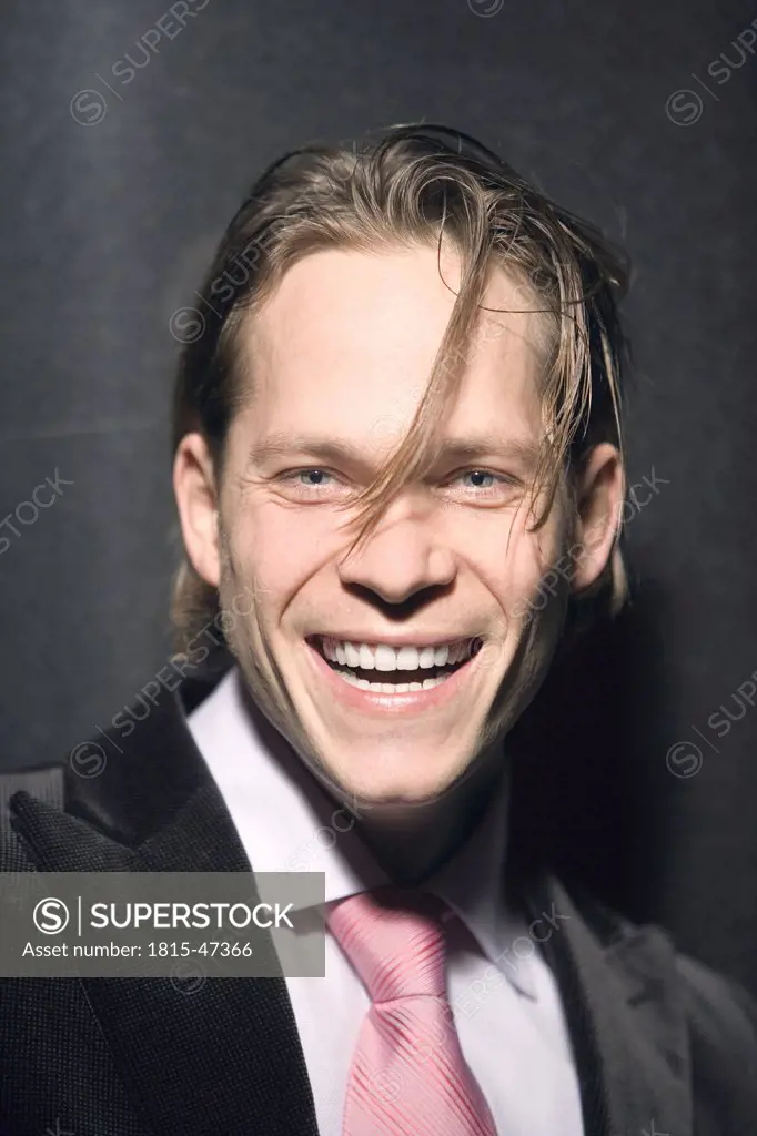 Young businessman, laughing, portrait