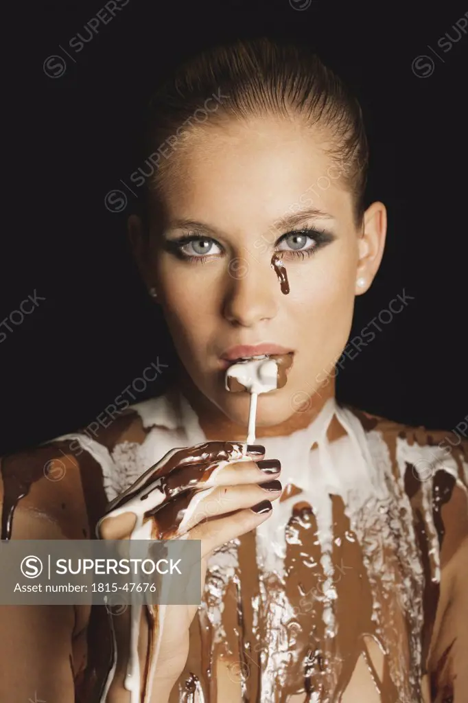 Young woman with melted chocolate on cleavage, portrait