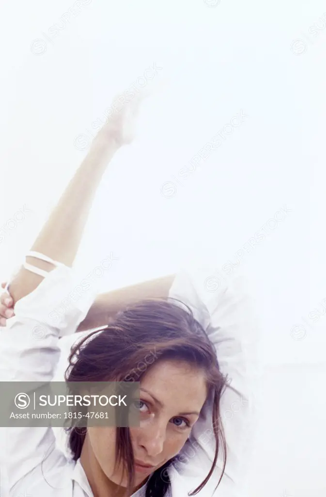 Young woman stretching arms, portrait