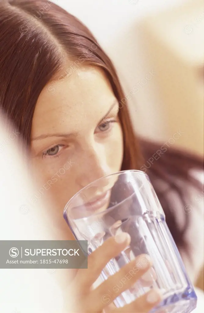 Young woman holding glass, portrait