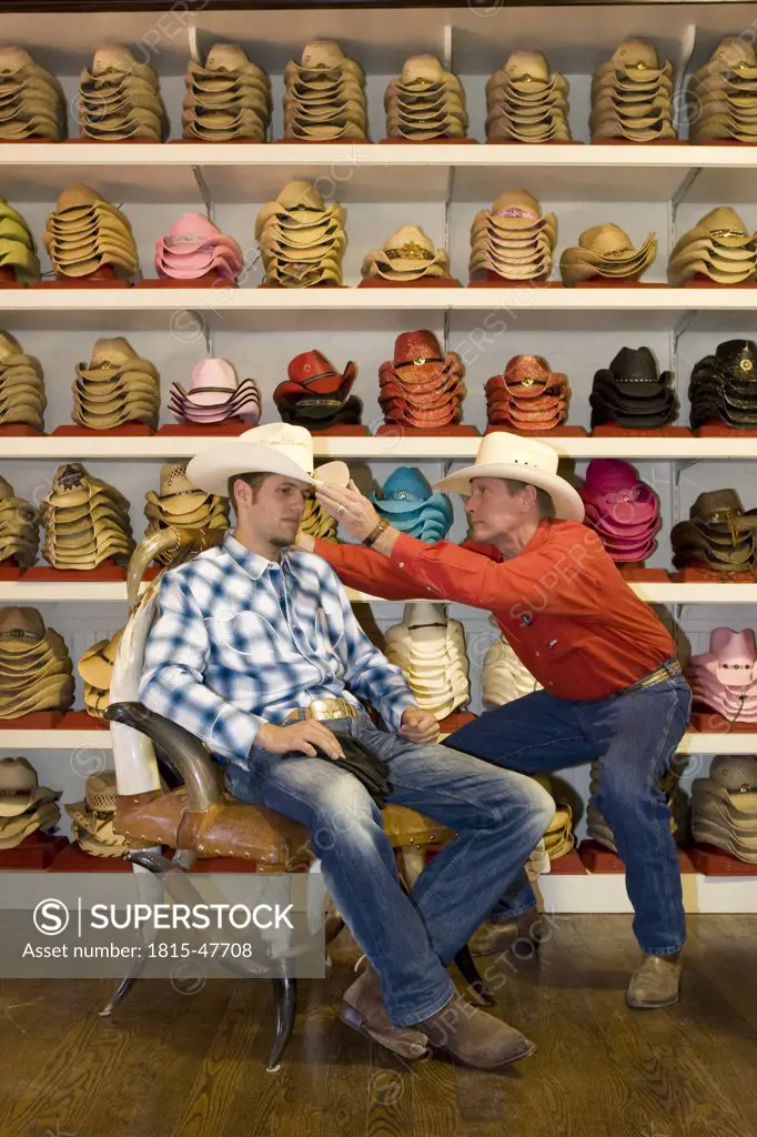 USA, Texas, Dallas, Man trying cowboy hat on