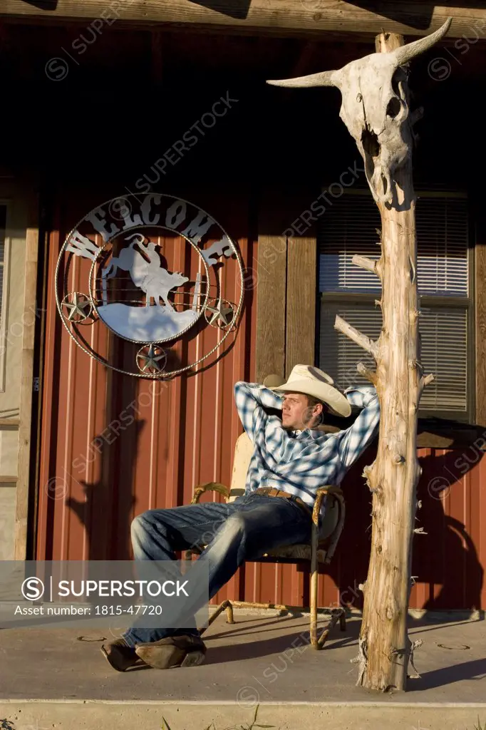 USA, Texas, Dallas, Cowboy sitting on Veranda