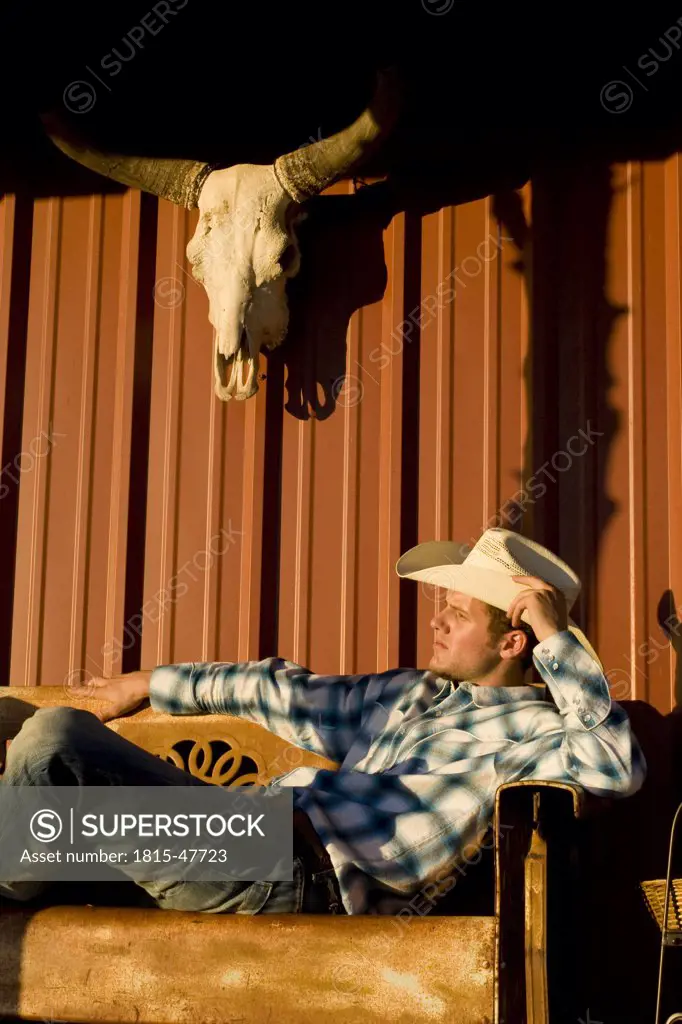 USA, Texas, Dallas, Cowboy sitting on Veranda