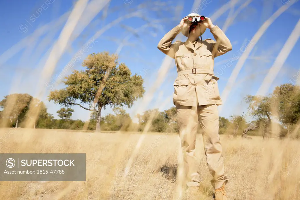 Africa, Botswana, Okavango Delta, Man looking through binoculars