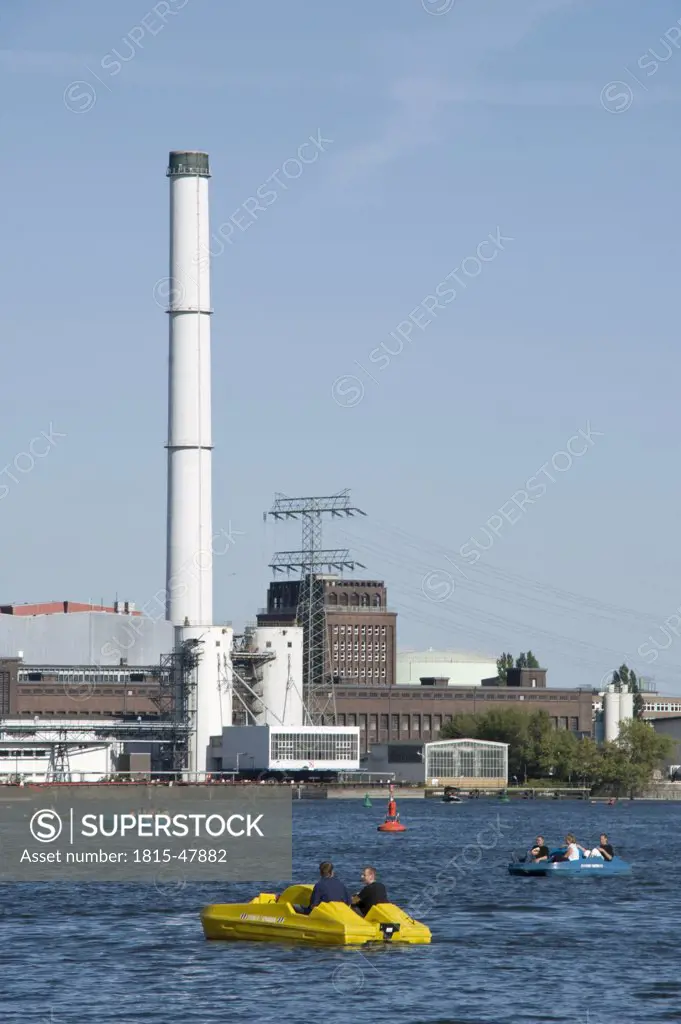 Germany, Berlin, Pedal boats on Spree river, Power station in the background