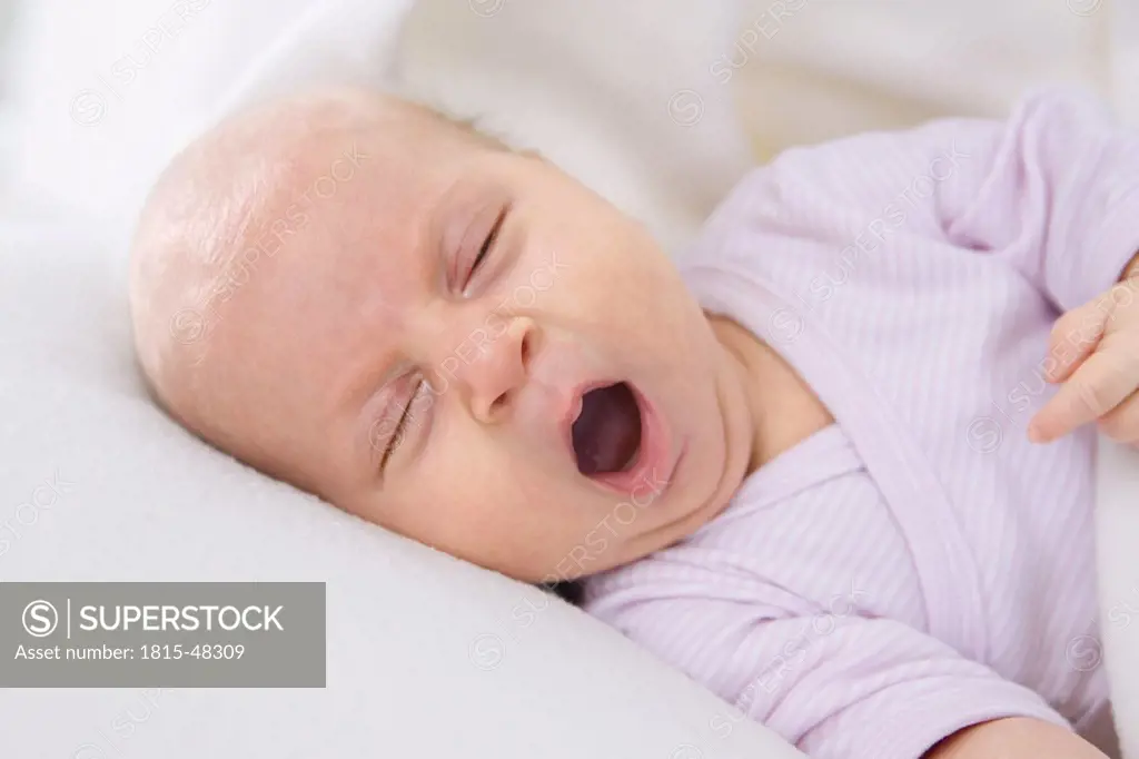 Baby girl (2 months) yawning, portrait