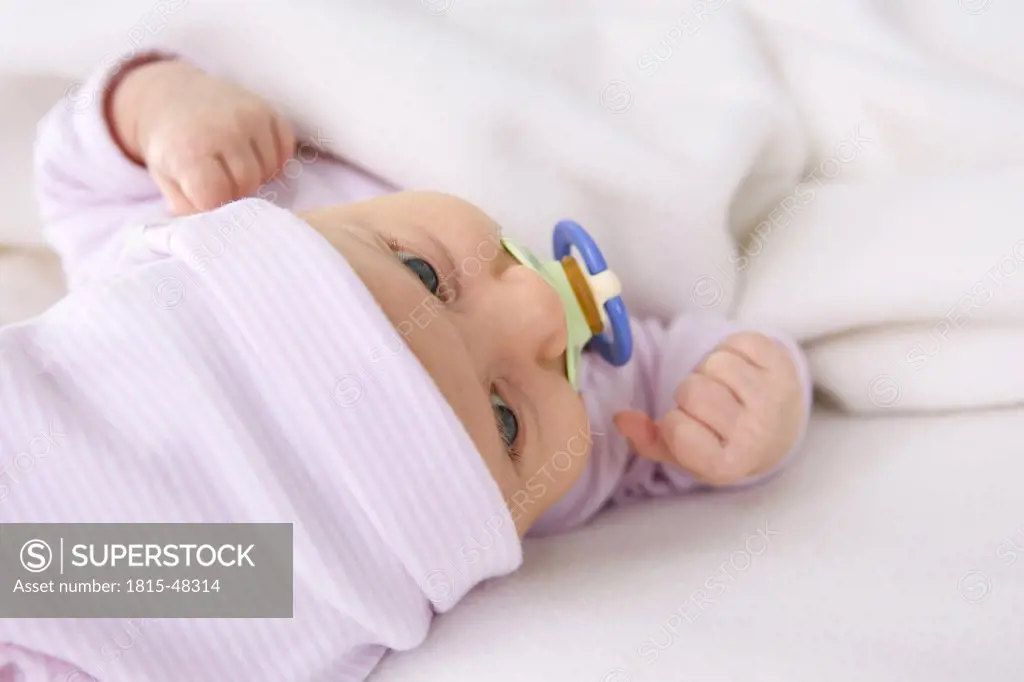 Baby girl (2 months) with pacifier, portrait