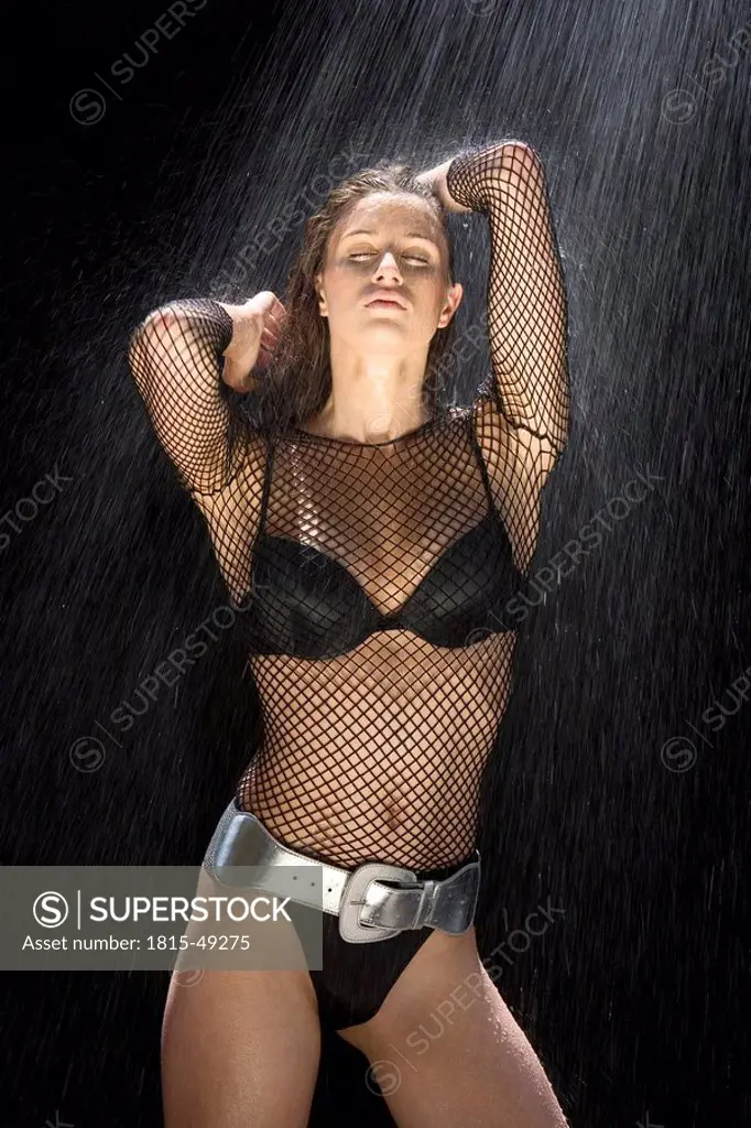 Young woman in bikini having a shower, portrait
