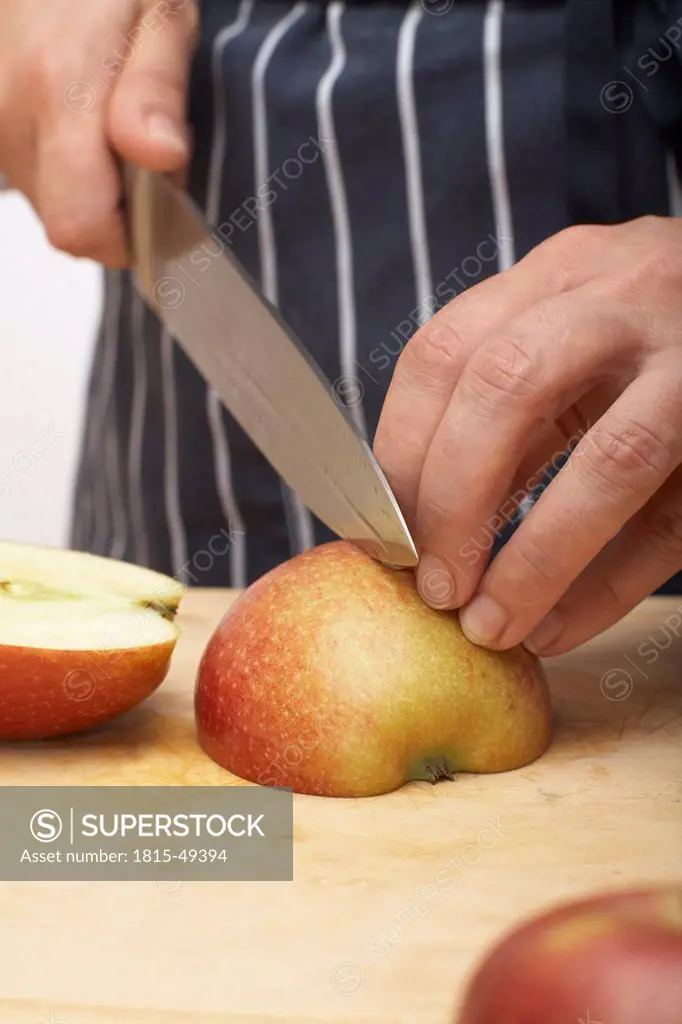 Person cutting an apple into quarters, close_up