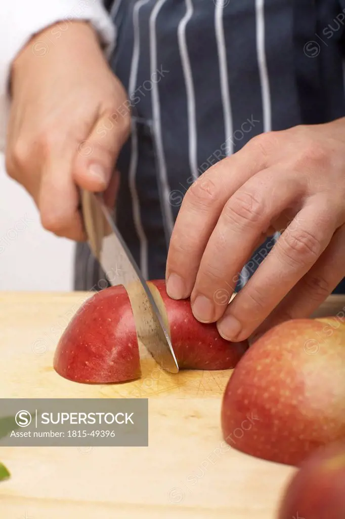 Person cutting an apple into quarters, close_up