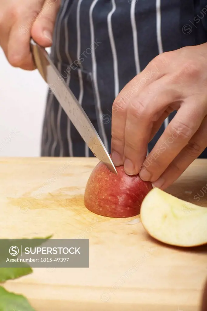 Person cutting an apple, close up