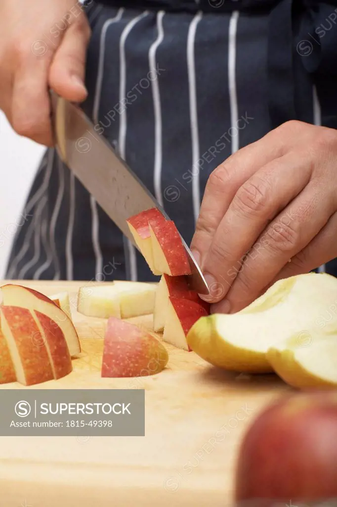 Person cutting apple pieces, close up