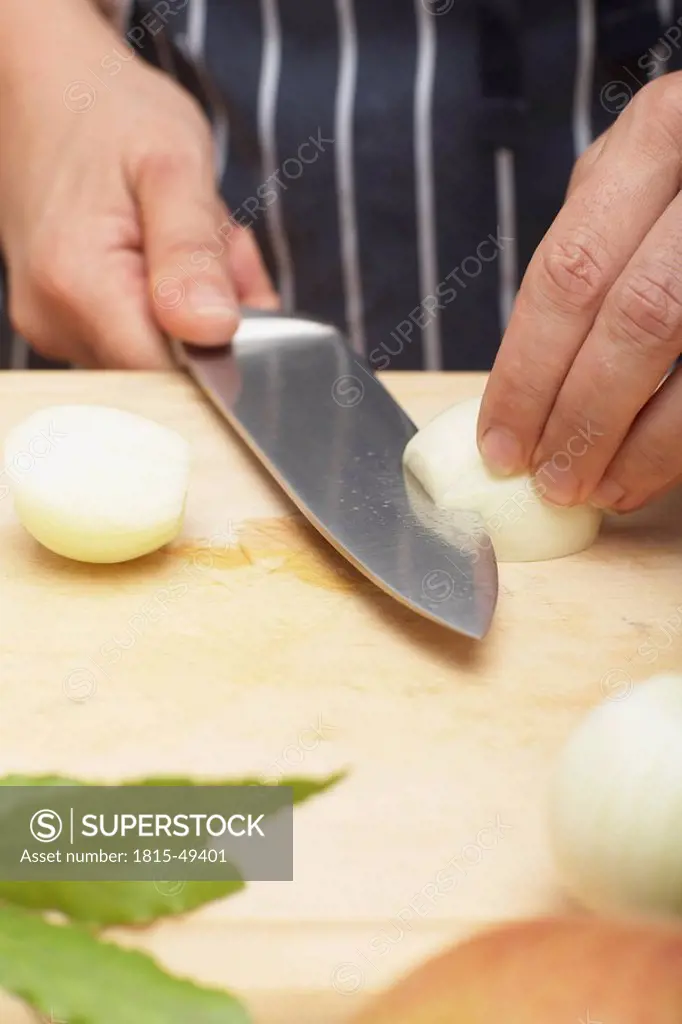 Person slicing an onion, close_up