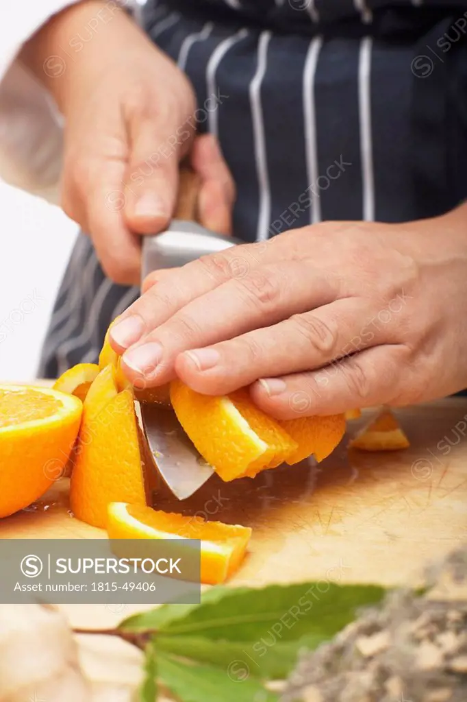 Person cutting an orange, close_up