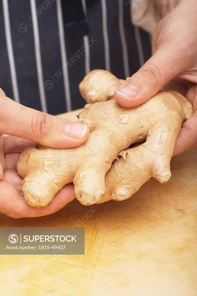 Person holding ginger root, close_up