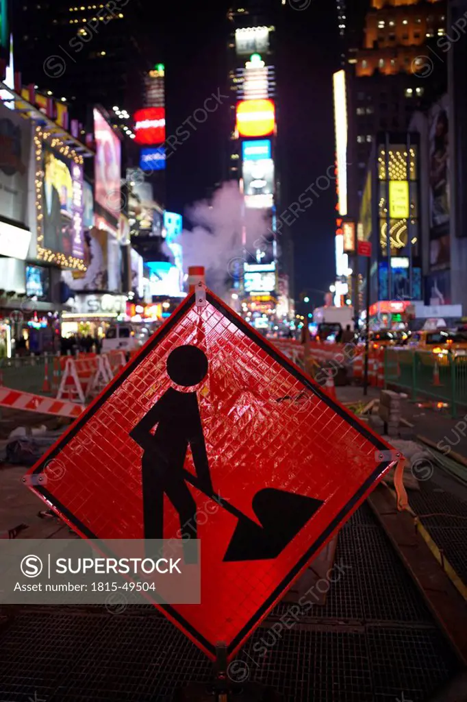 USA, New York City, Manhattan, Work in progress sign in foreground, Times Square at night
