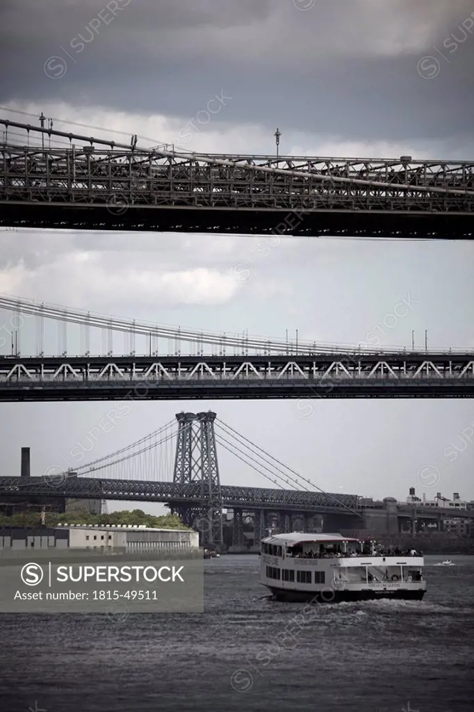 USA, New York City, Manhattan, Boat on river, bridges in background